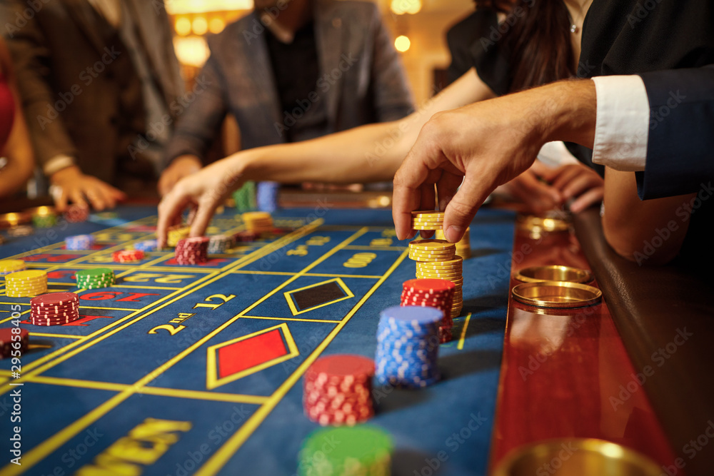A group of people gamblers playing gambling poker roulette in a casino