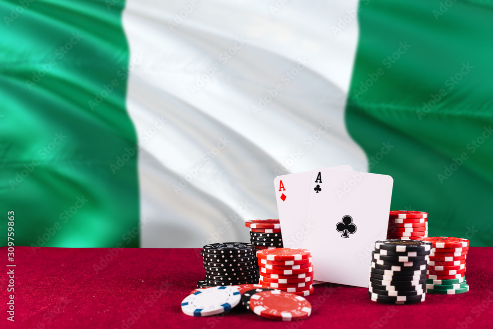 Nigeria casino theme. Aces in poker game, cards and chips on red table with national flag background. Gambling and betting.